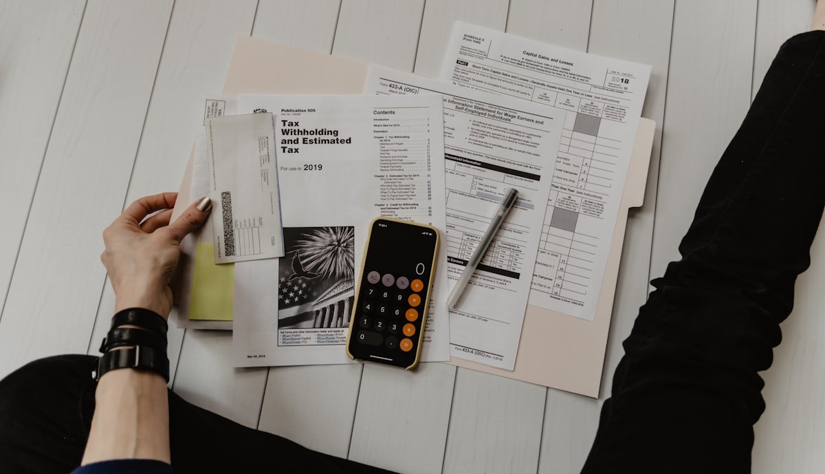 Founder doing HRMS pricing math at desk